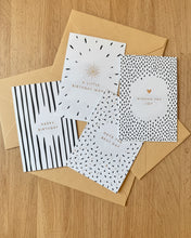Load image into Gallery viewer, Five birthday greeting cards with minimalist black and white patterns, arranged on top of kraft paper envelopes over a dark speckled countertop.
